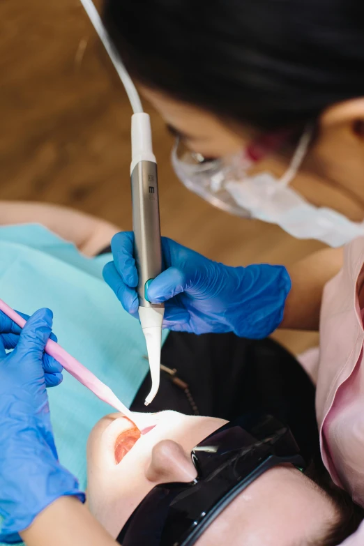a woman getting her teeth examined by a dentist, a digital rendering, pexels contest winner, with electric arc device, cysts, youtube thumbnail, uniform teeth