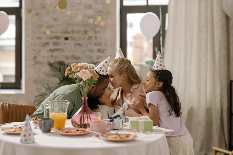 a family sitting at a table celebrating a birthday, pexels, hyperrealism, lovely kiss, diverse, decoration, over the shoulder