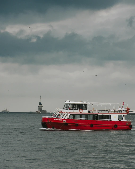 a red and white boat on a body of water, 🚿🗝📝, on a rainy day, black sea, lgbtq