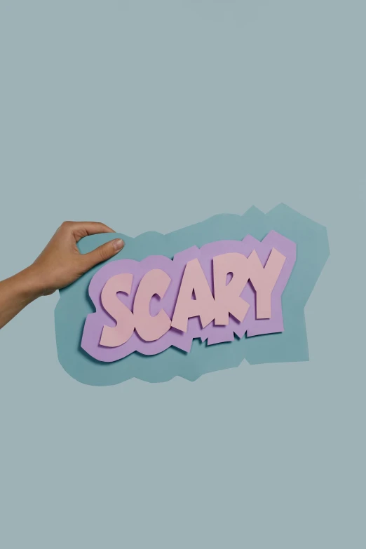 a person holding up a sign that says scary, by Rachel Reckitt, paper cutouts of plain colors, chillhop, mid view, on a pale background