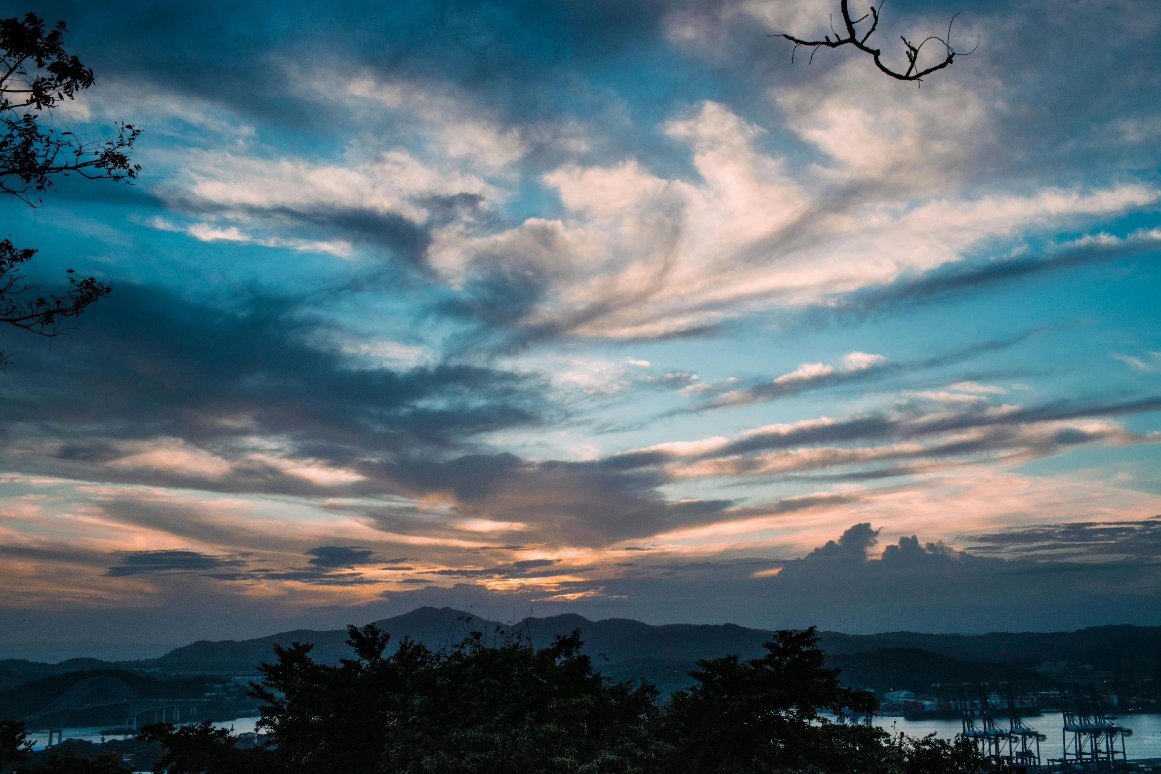 a large body of water under a cloudy sky, a picture, unsplash contest winner, romanticism, guwahati, sunset in a valley, thumbnail, multiple stories