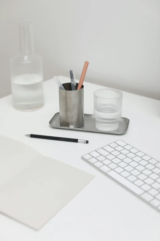 a laptop computer sitting on top of a white desk, by Mathias Kollros, trending on unsplash, square lines, pencil, made of brushed steel, silver small small small glasses
