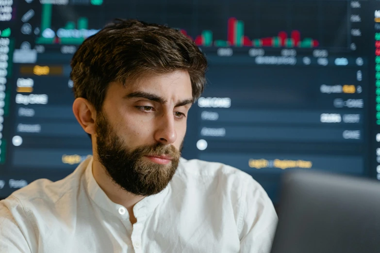 a man sitting in front of a laptop computer, a screenshot, trending on pexels, analytical art, facial actuary, looking serious, trading, professional profile picture