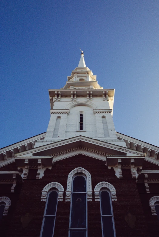 a tall tower with a clock on top of it, an album cover, unsplash, new england architecture, churches, 1990s photograph, sunlit