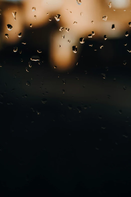 a rain covered window with a building in the background, pexels contest winner, clear dark background, water droplet, humid evening, 4 k hd wallpapear