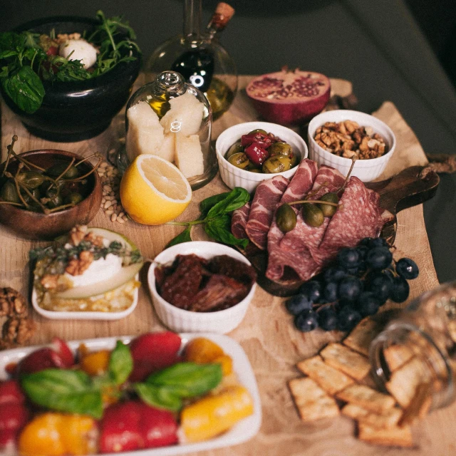 a wooden table topped with different types of food, by Daniel Lieske, pexels, renaissance, basil gogos, olives, 🦩🪐🐞👩🏻🦳, full body image