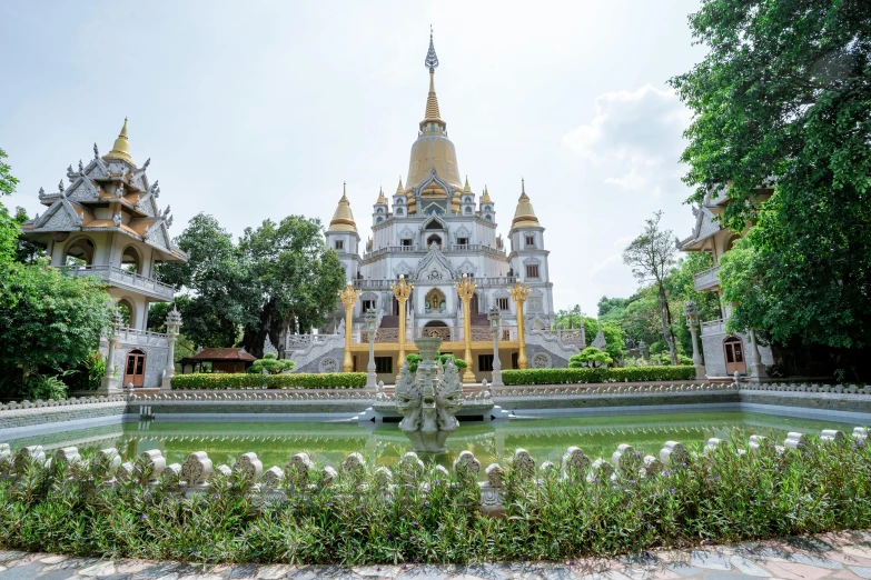 a large building with a fountain in front of it, inspired by Ruth Jên, white marble and gold, pagoda, vietnam, multicoloured