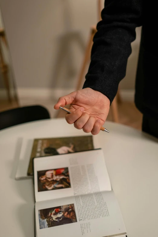 a person cutting a cake with a knife, an album cover, by Jan Tengnagel, unsplash, visual art, pair of keycards on table, thin soft hand holding cigarette, museum catalog photography, on a coffee table