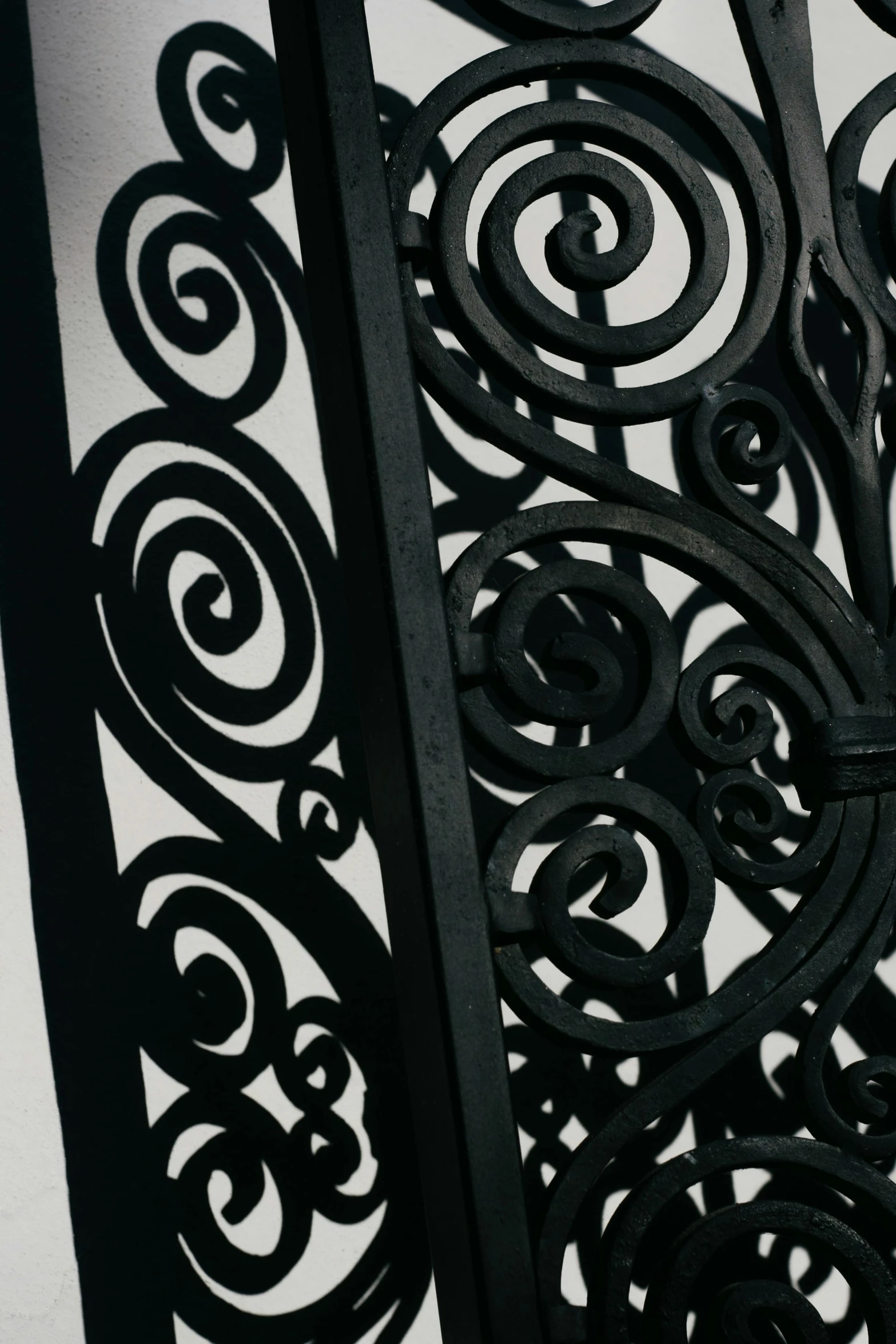 a clock that is on the side of a building, by Carey Morris, unsplash, arts and crafts movement, iron gate door texture, swirls, black lacquer, detail structure