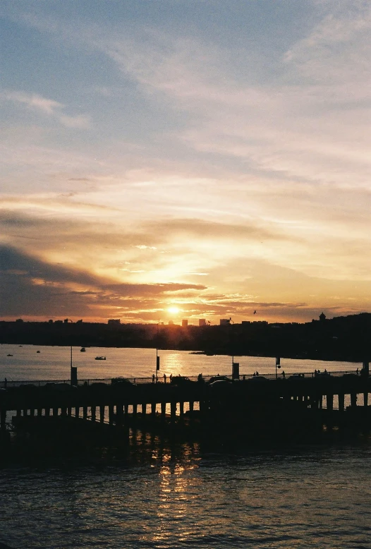 the sun is setting over a body of water, a picture, happening, thames river, docks, a 35mm photo, manly