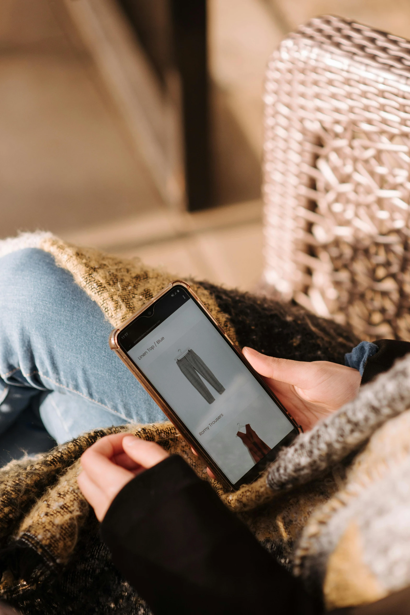 a person sitting on a couch holding a cell phone, detailed clothing, unsplash transparent, multiple stories, cardboard