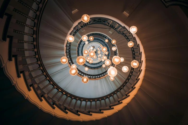 a spiral staircase with a lot of lights on it, pexels contest winner, fan favorite, balls of light for eyes, escher, symmetrical rim light