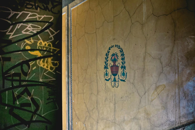 a toilet sitting next to a wall covered in graffiti, a detailed painting, by Elsa Bleda, unsplash, graffiti, inlaid with gold rococo, painted pale yellow and green, cartouche, medium [ graffiti