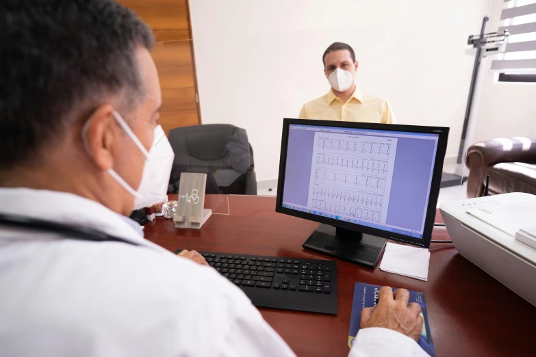 a man sitting at a desk in front of a computer, masked doctors, ignacio fernández ríos, customers, 15081959 21121991 01012000 4k