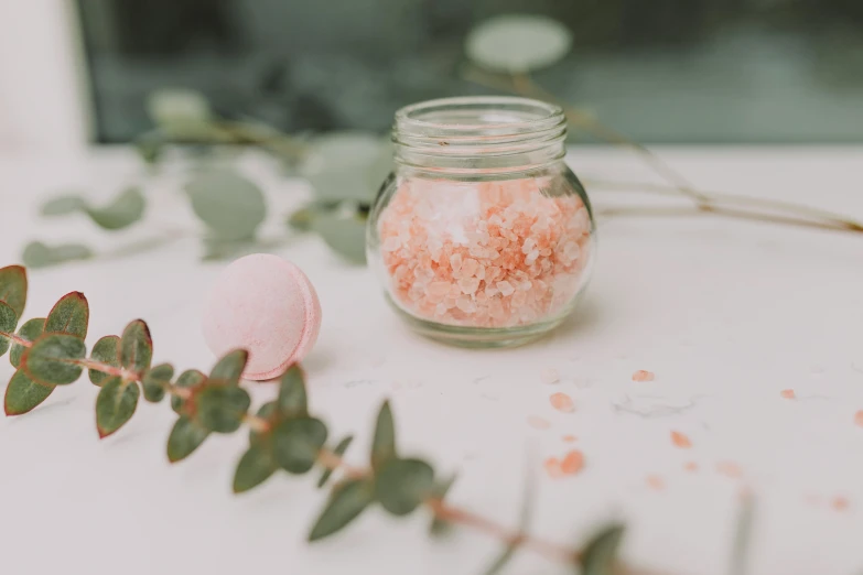 a jar of bath salts sitting on top of a table, by Emma Andijewska, pexels, peach embellishment, bubblegum, gardening, gif