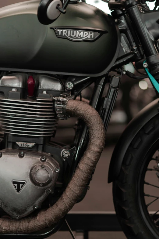 a close up of a motorcycle parked on a street, by Tom Bonson, hoses:10, triumph, 8k detail, retro colour