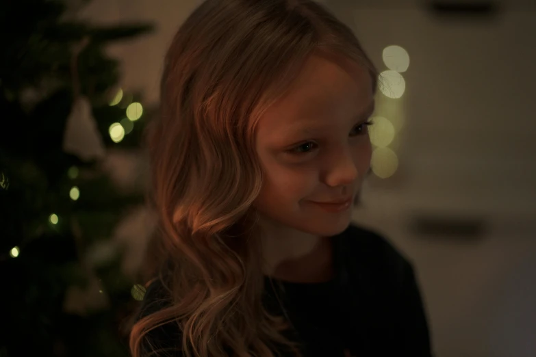 a little girl standing in front of a christmas tree, pexels contest winner, incoherents, portrait soft low light, teenage girl, light stubble, gif