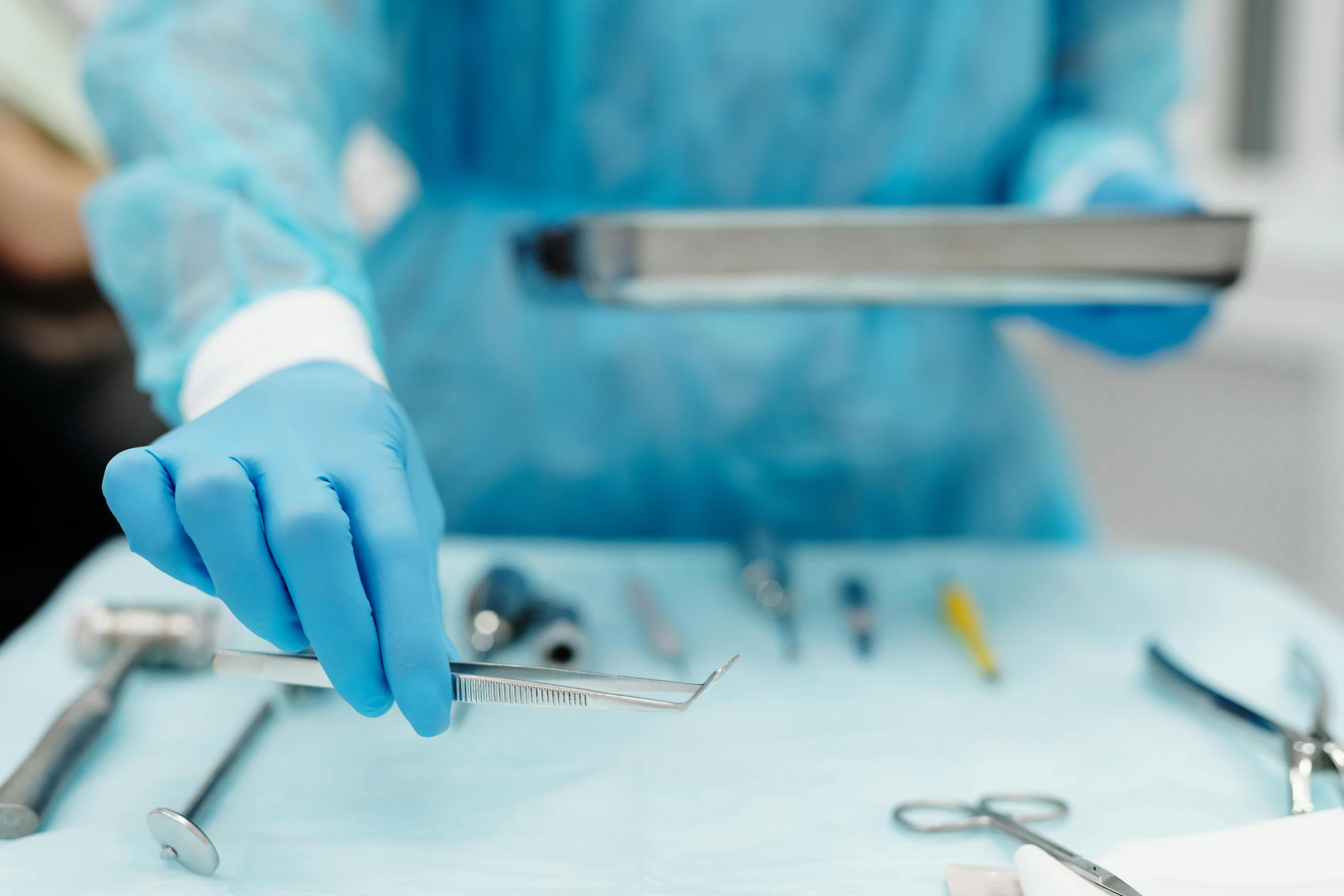 a person in blue gloves holding a pair of scissors, shutterstock, surgery table, electronic components, multiple stories, anaesthetic