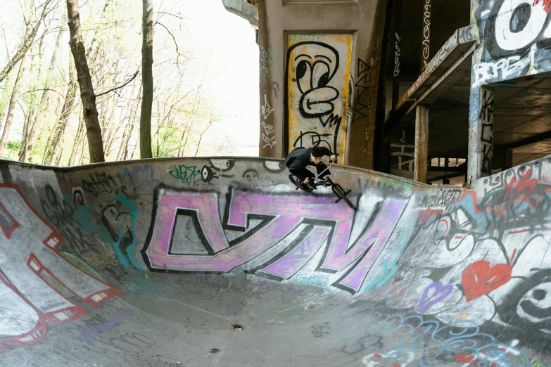 a man riding a skateboard up the side of a ramp, a picture, graffiti, bowl, in karuizawa, 4k photo”, ruin