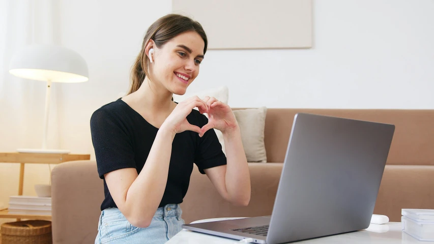 a woman sitting in front of a laptop computer, trending on pexels, heart shaped face, australian, various posed, instagram picture