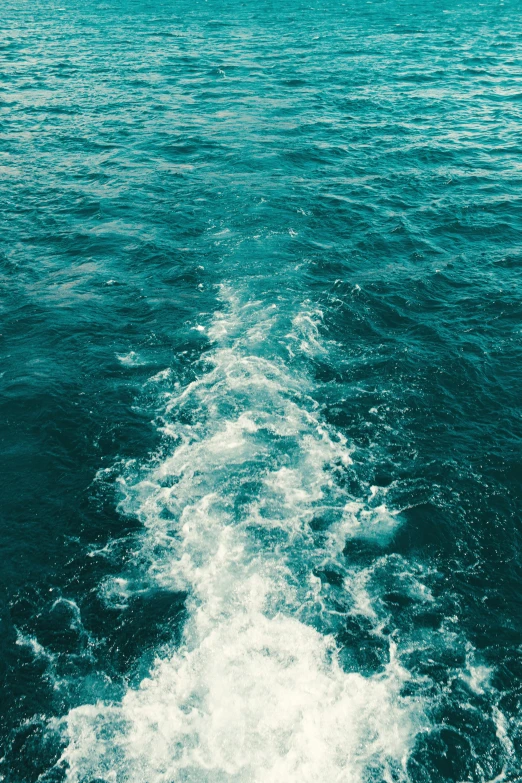 a view of the ocean from the back of a boat, an album cover, trending on unsplash, running water, ocean pattern, floating. greenish blue, made of water