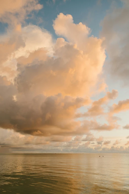 a person riding a surfboard on top of a body of water, by Jan Tengnagel, minimalism, orange clouds, cumulus, ox, sunlit