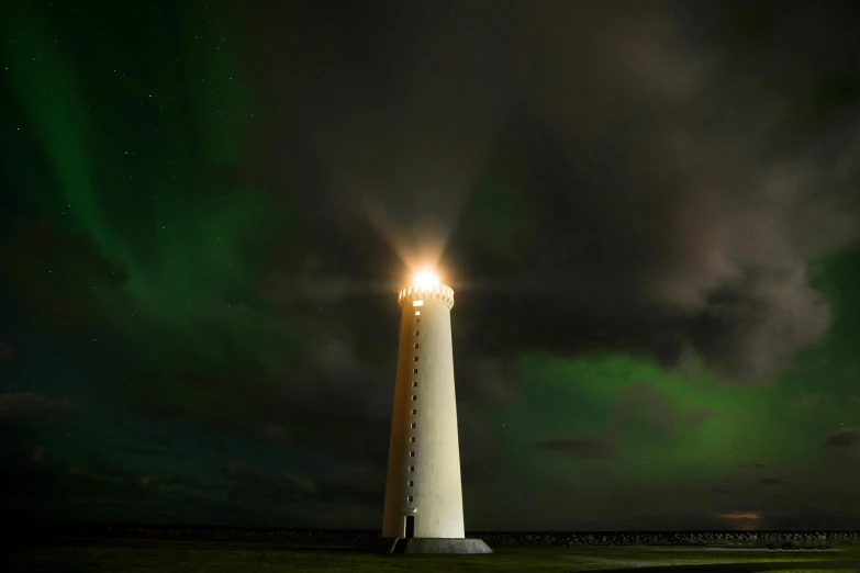 a light house sitting on top of a lush green field, an album cover, by Hallsteinn Sigurðsson, pexels contest winner, romanticism, dramatic aurora borealis, white, light cone, light green