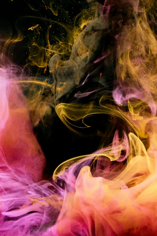 a close up of colored smoke on a black background, inspired by Kim Keever, pexels, yellow and purple tones, swirls, colored ink, pink and orange colors