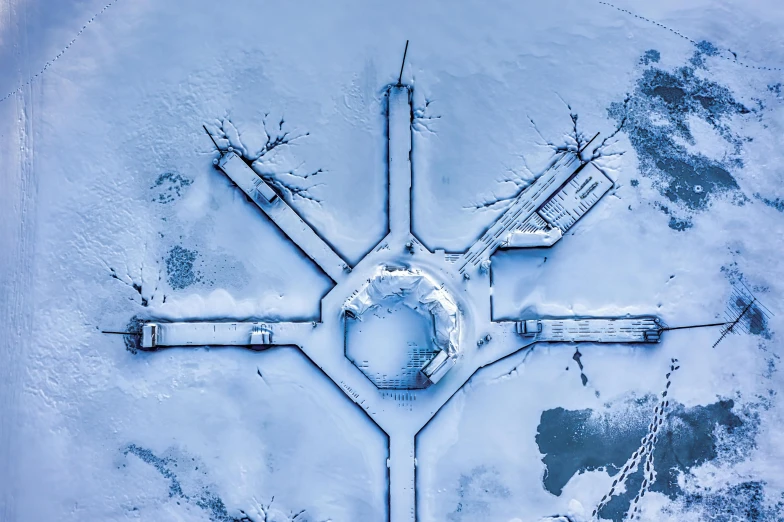 an aerial view of a building in the snow, a microscopic photo, by Jesper Knudsen, pexels contest winner, land art, ice arrows, military base, cold blue colors, thumbnail