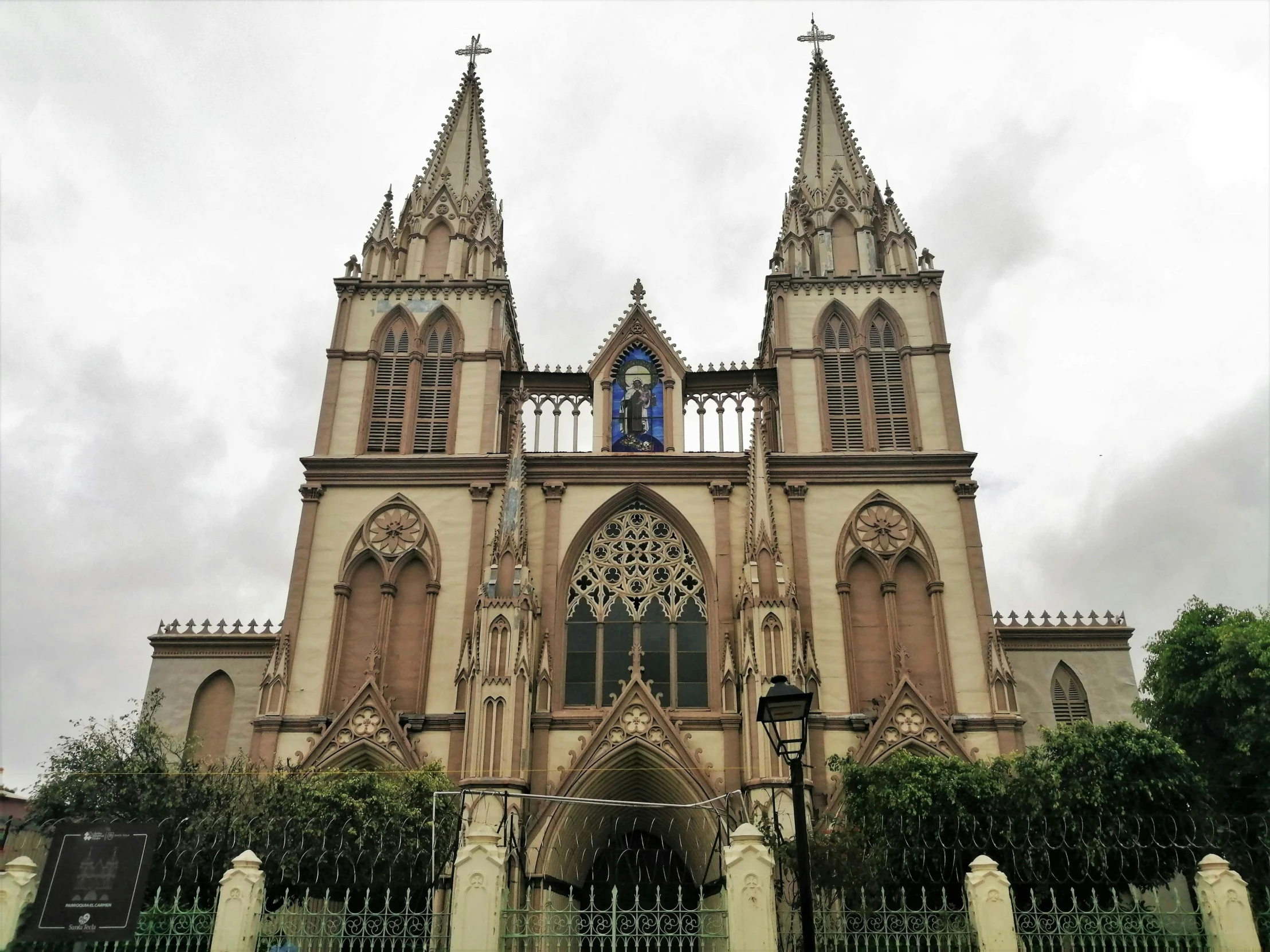 a large cathedral with a clock on top of it, guangjian, gothic revival, on a cloudy day, 👰 🏇 ❌ 🍃