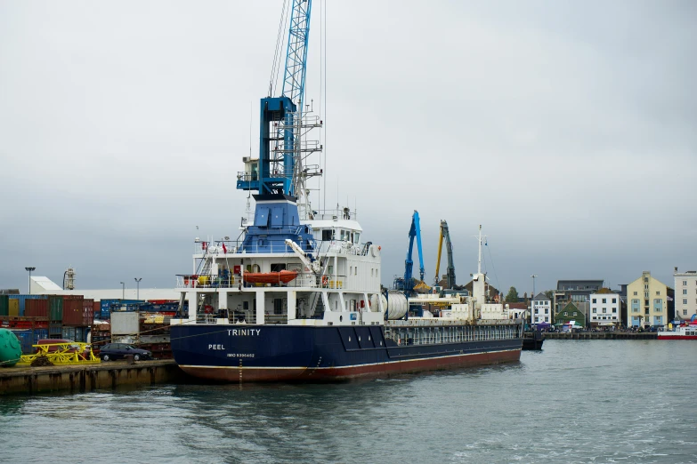 a large blue and white boat in a body of water, a portrait, shipping docks, taken with sony alpha 9, full device, mining