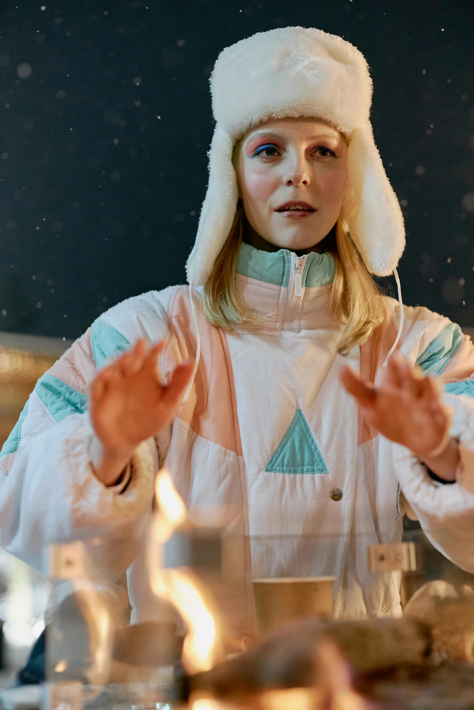 a woman sitting at a table with candles in front of her, inspired by Louisa Matthíasdóttir, wearing astronaut outfit, marshmallow, peak experience ”, wearing festive clothing