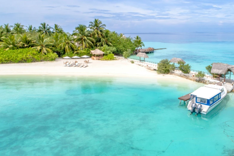 a boat that is sitting in the water, by Julian Allen, pexels contest winner, hurufiyya, beautiful tropical island beach, helicopter view, beachfront mansion, unfinished roots of white sand