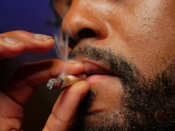 a close up of a person smoking a cigarette, black man, pot leaf, thumbnail, cysts