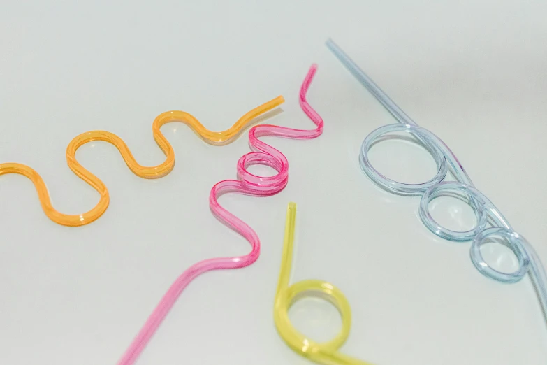 a close up of a pair of scissors on a table, inspired by Cerith Wyn Evans, plasticien, made of drink, spiral lines, 3 colours, close-up product photo