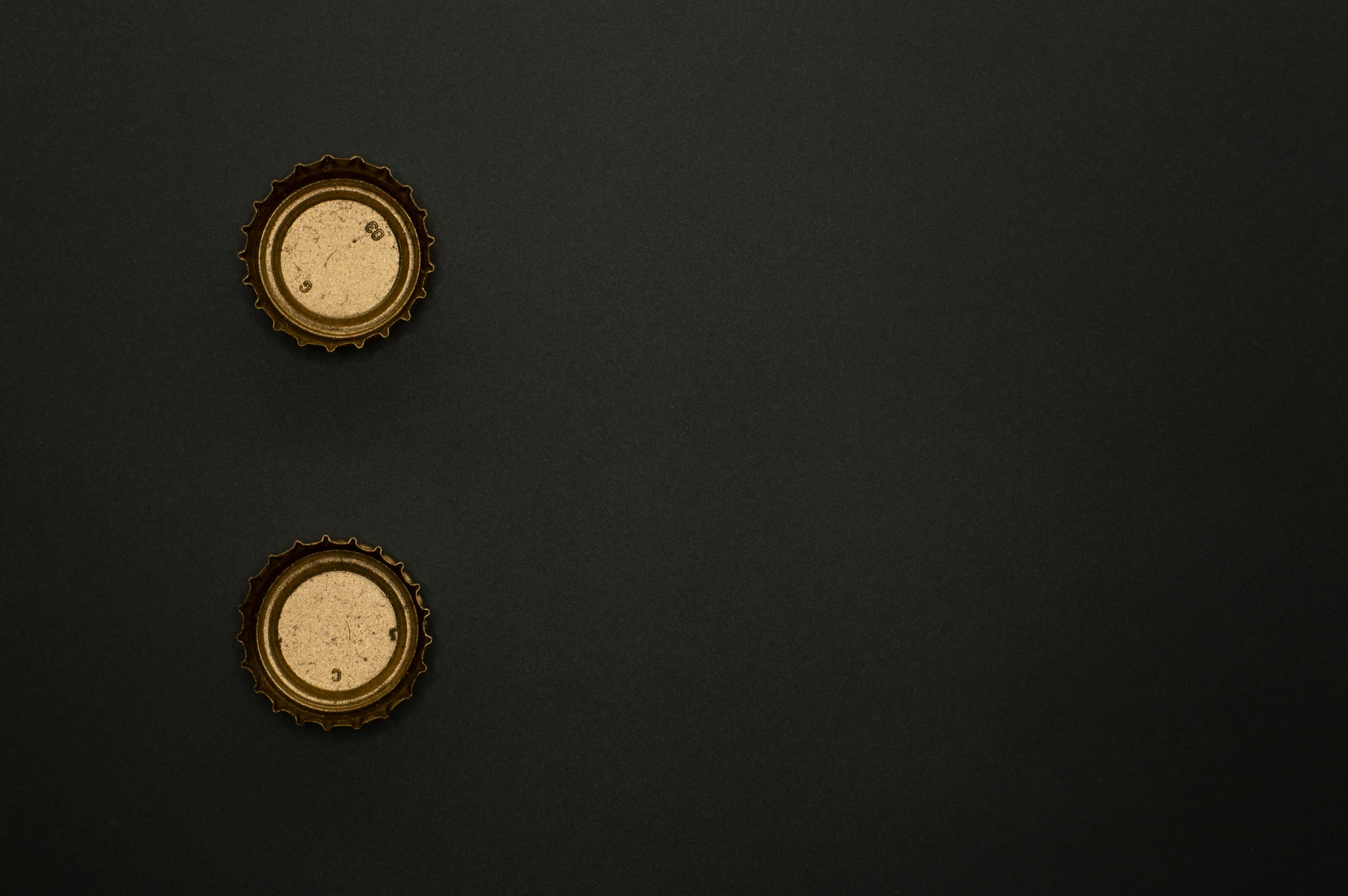 a couple of clocks sitting on top of a black wall, an album cover, by Andries Stock, trending on unsplash, minimalism, surface with beer-texture, golden miniatures, ignant, brown holes