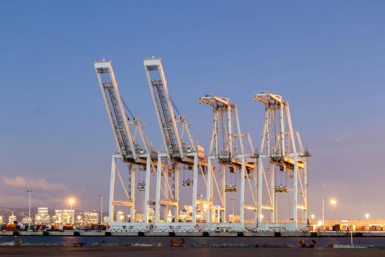 a group of cranes sitting on top of a body of water, a digital rendering, by Brad Holland, pexels contest winner, shipping docks, avatar image, california, lit from the side