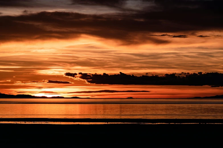 a person riding a horse on a beach at sunset, by Andrew Allan, pexels contest winner, black and orange colour palette, sunset panorama, haida, burning clouds