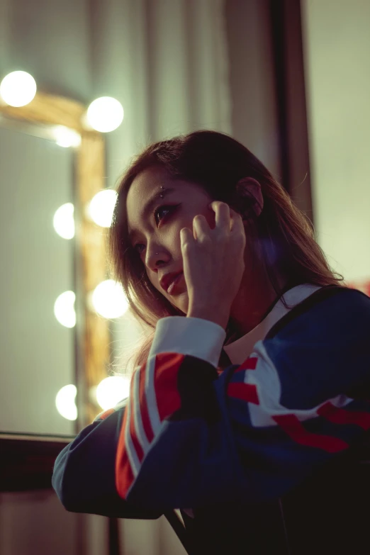 a woman talking on a cell phone in front of a mirror, inspired by Elsa Bleda, trending on pexels, realism, korean kpop star, sad lighting, tzuyu from twice, concert