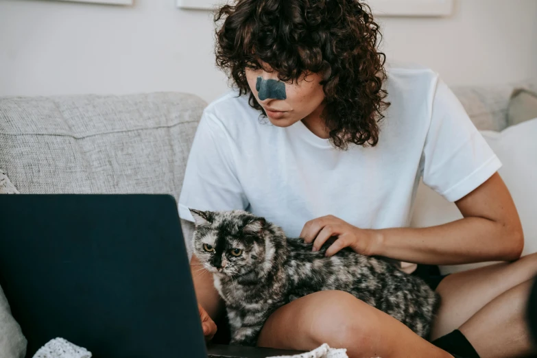 a woman sitting on a couch with a cat and a laptop, trending on pexels, cute bandaid on nose!!, avatar image, mixed animal, human photo