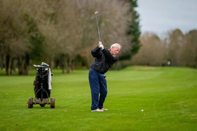 a man swinging a golf club at a golf course, happening, portrait of hide the pain harold, peter marlow photography, uploaded, schools