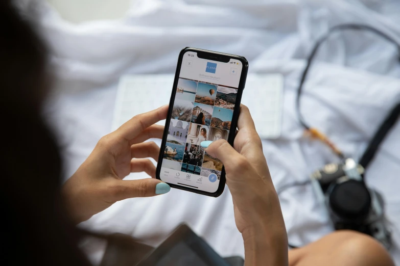 a woman sitting on top of a bed holding a cell phone, a picture, trending on pexels, instagram post 4k, everything fits on the screen, zoomed out to show entire image, multiple stories