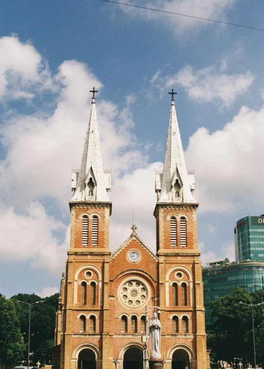 a group of people standing in front of a church, inspired by Ruth Jên, trending on unsplash, vietnam, high rises, square, low quality photo
