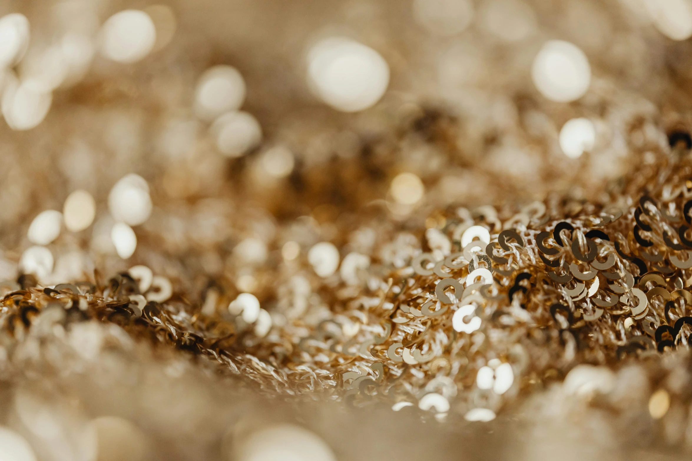 a close up of a bunch of beads, a macro photograph, by Julia Pishtar, trending on pexels, gold cloth, sequins, silver，ivory, gold chain