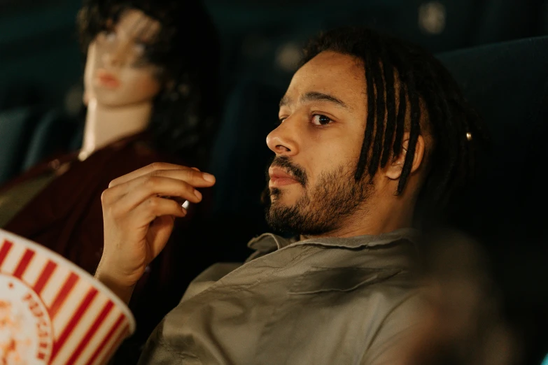 a man sitting next to a woman in a movie theater, pexels contest winner, fantastic realism, trippie redd, alejandro inarritu, smooth in _ the background, rotoscope