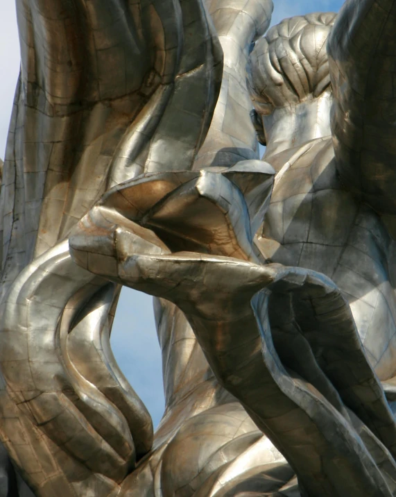 a close up of a statue with a sky background, by Ossip Zadkine, pexels contest winner, art nouveau, an enormous silver tree, bulging veins, legs intertwined, swirling silver fish
