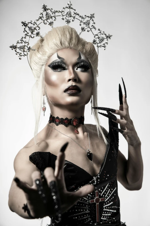 a woman in a black corset holding a pair of scissors, an album cover, inspired by Lam Qua, featured on reddit, transgressive art, wearing a crown made of antlers, beautiful male drow, 2019 trending photo, asian human