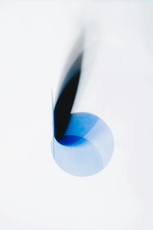 a blue toothbrush sitting on top of a white surface, by Doug Ohlson, lyrical abstraction, dynamic folds, circle forms, 2 0 5 6, close-up photograph