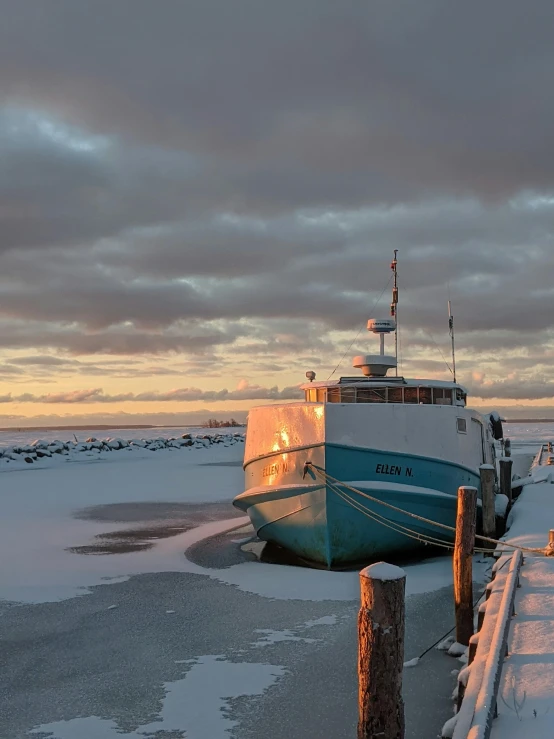 a boat sitting on top of a frozen lake, by Harald Giersing, docked at harbor, mid morning lighting, frozen sea, iceland landscape photography