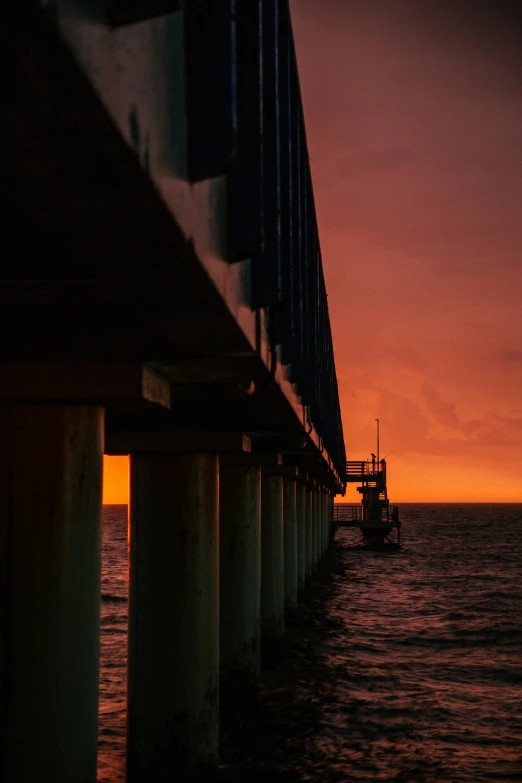 a bridge over a body of water at sunset, by Brad Holland, offshore winds, color ( sony a 7 r iv, tubes, on ship